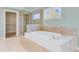 Luxurious bathroom with a soaking tub, walk-in shower, and a large window at 107 Minus St, Saint George, SC 29477