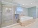 Modern bathroom with a glass shower, a luxurious soaking tub, and tile floors at 107 Minus St, Saint George, SC 29477