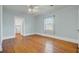 Light blue bedroom with wood floors, window, and ensuite laundry room at 107 Minus St, Saint George, SC 29477