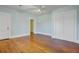 Light blue bedroom with wood floors, ceiling fan, closet, and two doors at 107 Minus St, Saint George, SC 29477