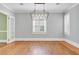 Spacious dining room with hardwood floors, neutral paint, and a contemporary light fixture at 107 Minus St, Saint George, SC 29477