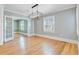 Inviting dining room with hardwood floors, open layout, and abundant natural light from large windows at 107 Minus St, Saint George, SC 29477