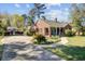 Beautiful brick home with a charming front porch, driveway and lush landscaping, offering classic curb appeal at 107 Minus St, Saint George, SC 29477