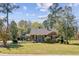 Charming brick home with a well-manicured lawn and classic design with inviting curb appeal and mature trees at 107 Minus St, Saint George, SC 29477