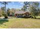 Charming brick home with a well-manicured lawn and classic design with inviting curb appeal and mature trees at 107 Minus St, Saint George, SC 29477