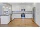 Modern kitchen featuring white cabinets, granite countertops, and stainless steel appliances at 107 Minus St, Saint George, SC 29477