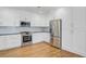 Bright kitchen with white cabinets, subway tile backsplash, and stainless steel appliances at 107 Minus St, Saint George, SC 29477