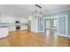 Open-concept kitchen featuring white cabinets, hardwood floors, and stainless steel appliances at 107 Minus St, Saint George, SC 29477