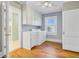 Bright laundry room with washer, dryer, sink, and hardwood floors at 107 Minus St, Saint George, SC 29477