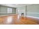 Living room features hardwood floors, a fireplace, and light green walls creating a bright and open space at 107 Minus St, Saint George, SC 29477