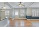 Open living room featuring hardwood floors, a ceiling fan, and plenty of natural light from windows at 107 Minus St, Saint George, SC 29477