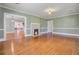 Spacious living room with hardwood floors, fireplace, and view into other rooms, offering an open and airy feel at 107 Minus St, Saint George, SC 29477