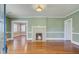 Bright living room with fireplace, hardwood floors, and view into another room, creating a warm and inviting space at 107 Minus St, Saint George, SC 29477
