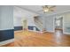 Spacious living room boasts hardwood floors, neutral paint, a ceiling fan, and staircase at 107 Minus St, Saint George, SC 29477