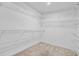 Spacious walk-in closet featuring ample shelving and neutral carpeting at 107 Minus St, Saint George, SC 29477