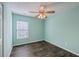 Bright bedroom with dark wood floors and a window, complemented by a stylish ceiling fan at 108 Chemistry Cir, Ladson, SC 29456