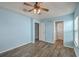 This spacious bedroom has wood flooring, a ceiling fan, and doors to other rooms at 108 Chemistry Cir, Ladson, SC 29456