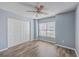 A well-lit bedroom featuring a closet, ceiling fan, and a window with a view at 108 Chemistry Cir, Ladson, SC 29456