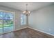 Cozy dining room features an elegant chandelier and sliding glass doors to a backyard patio at 108 Chemistry Cir, Ladson, SC 29456