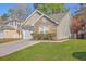 Home's exterior features a mix of siding, stone accents, and a well-maintained lawn at 108 Chemistry Cir, Ladson, SC 29456