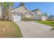 The home boasts a stone facade, garage and an inviting curb appeal enhanced by a green lawn at 108 Chemistry Cir, Ladson, SC 29456