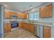 This kitchen is equipped with stainless steel appliances, granite countertops, and wooden cabinets at 108 Chemistry Cir, Ladson, SC 29456