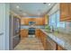 This kitchen features stainless steel appliances, granite countertops, and wooden cabinetry at 108 Chemistry Cir, Ladson, SC 29456