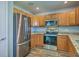 This kitchen features stainless steel appliances, granite countertops, and wooden cabinetry at 108 Chemistry Cir, Ladson, SC 29456