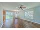 Open living space with hardwood floors, a ceiling fan, and a sliding glass door to the backyard at 108 Chemistry Cir, Ladson, SC 29456