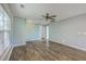 Bright living room with hardwood floors, ceiling fan, and several windows for natural light at 108 Chemistry Cir, Ladson, SC 29456