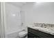 Bright bathroom with white shower-tub combo, granite countertop, and modern fixtures at 1146 Rivercrest Dr, Charleston, SC 29412