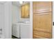 Bright laundry room with washer, dryer, and built-in storage cabinets at 1146 Rivercrest Dr, Charleston, SC 29412
