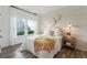 Cozy bedroom with natural light, stylish wall decor, a rattan side table and a colorful throw blanket at 1155 Darling St, Summerville, SC 29485