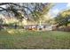 A backyard view showing a home with a deck and a wooded area at 1174 Fort Johnson Rd, James Island, SC 29412