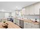 Modern kitchen featuring stainless steel appliances, butcher block countertops, and stylish white cabinets for a sleek design at 1174 Fort Johnson Rd, James Island, SC 29412
