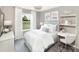 Bright bedroom with a comfortable bed, white and light blue decor, study desk, and a view of the outdoors at 123 Royal Cainhoy Way, Huger, SC 29450