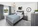 Stylish bedroom features a comfortable bed, accent lighting, and window with elegant blue curtains at 123 Royal Cainhoy Way, Huger, SC 29450
