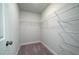 Spacious walk-in closet featuring white wire shelving, neutral walls and neutral carpet for easy storage at 123 Royal Cainhoy Way, Huger, SC 29450