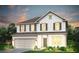 Charming two-story home features a symmetrical facade, a two-car garage, and professionally landscaped front yard at 123 Royal Cainhoy Way, Huger, SC 29450