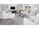 Bright living room features white couches and decorative pillows, complemented by wood style accent wall and modern decor at 123 Royal Cainhoy Way, Huger, SC 29450