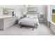 Serene main bedroom featuring a large bed, plush carpet, dresser, mirror, and a window offering a view of the outdoors at 123 Royal Cainhoy Way, Huger, SC 29450