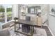 Bright office features a modern desk, neutral chair, built-in shelving, and large windows overlooking the greenery at 123 Royal Cainhoy Way, Huger, SC 29450