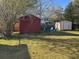 Large backyard featuring multiple storage sheds, outdoor seating, and plenty of green space at 1236 Fort Dr, Hanahan, SC 29410