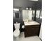Stylish bathroom features dark walls, vanity with marble countertop, and a mirror reflecting the shower at 1236 Fort Dr, Hanahan, SC 29410