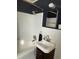 Bathroom featuring gold fixtures, all white tile, and a white sink at 1236 Fort Dr, Hanahan, SC 29410