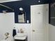 Bathroom features white subway tile, dark blue paint, brass fixtures and door with hook at 1236 Fort Dr, Hanahan, SC 29410
