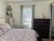Bedroom showcasing a patterned bedspread, a window and dark wood floors at 1236 Fort Dr, Hanahan, SC 29410