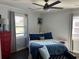 A sunny bedroom features a ceiling fan, ample natural light from two windows, and tasteful decor at 1236 Fort Dr, Hanahan, SC 29410