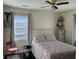 This bedroom features a patterned bedspread, a window and dark wood floors at 1236 Fort Dr, Hanahan, SC 29410