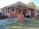 A well-maintained brick home with an extended carport and a tidy lawn area at 1236 Fort Dr, Hanahan, SC 29410